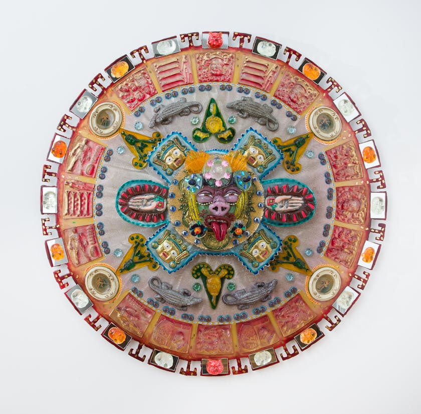 Colorful glass mandala with various faces and animals