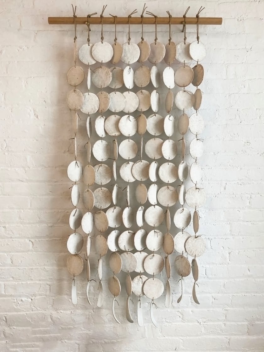 Wall art by Michele Quan featuring hanging discs