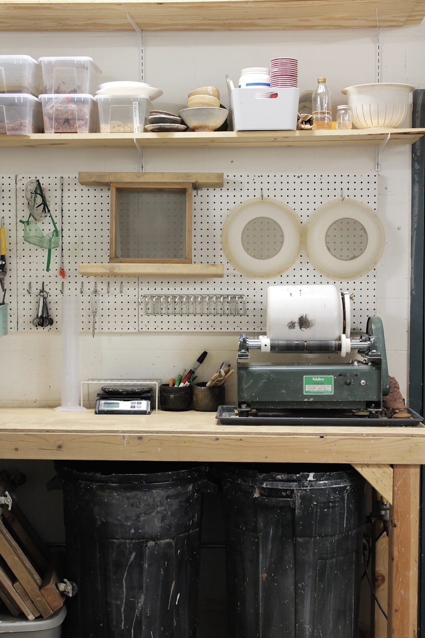 Studio work bench with various equipment and supplies