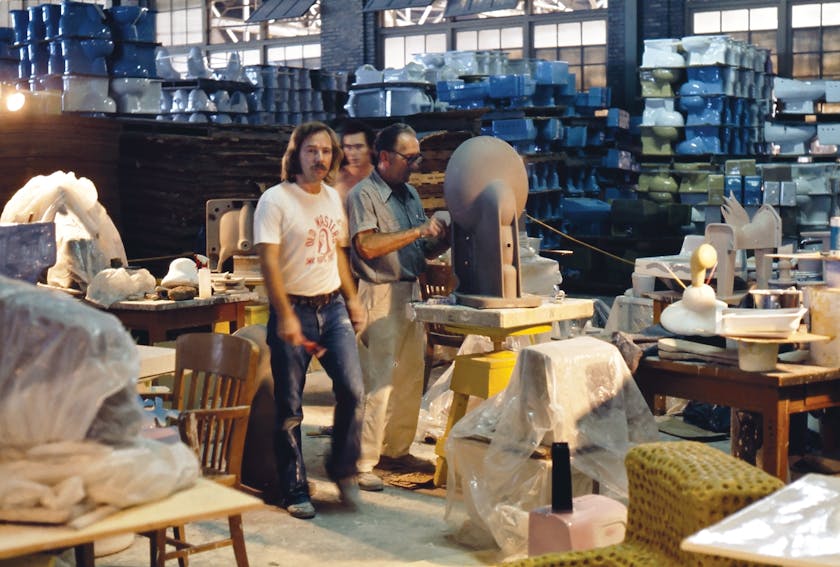 1974 photo of three people working in an industrial arts studio
