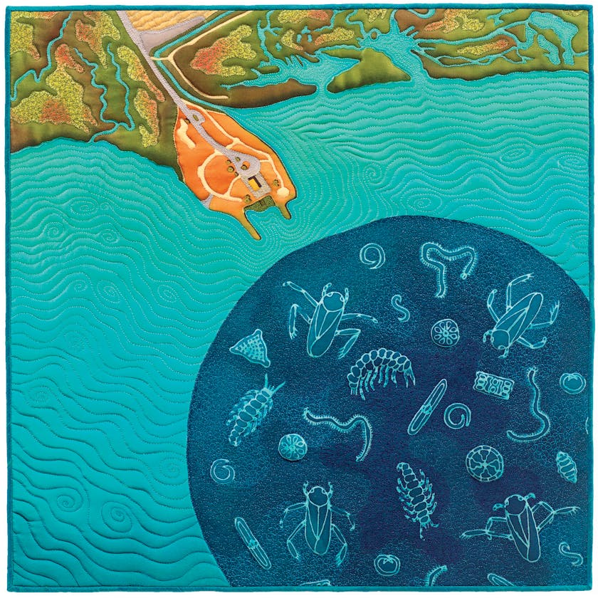 Square quilt depicting orange coast with sea creatures in the blue ocean