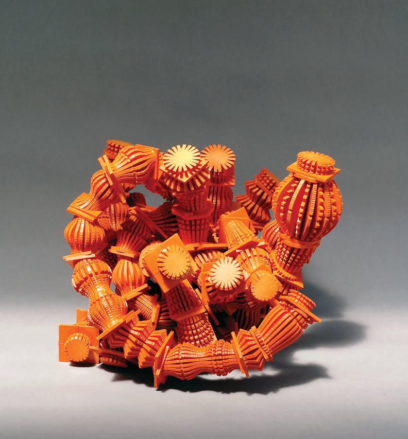 Orange tangled wood sculpture reminiscent of a sea creature