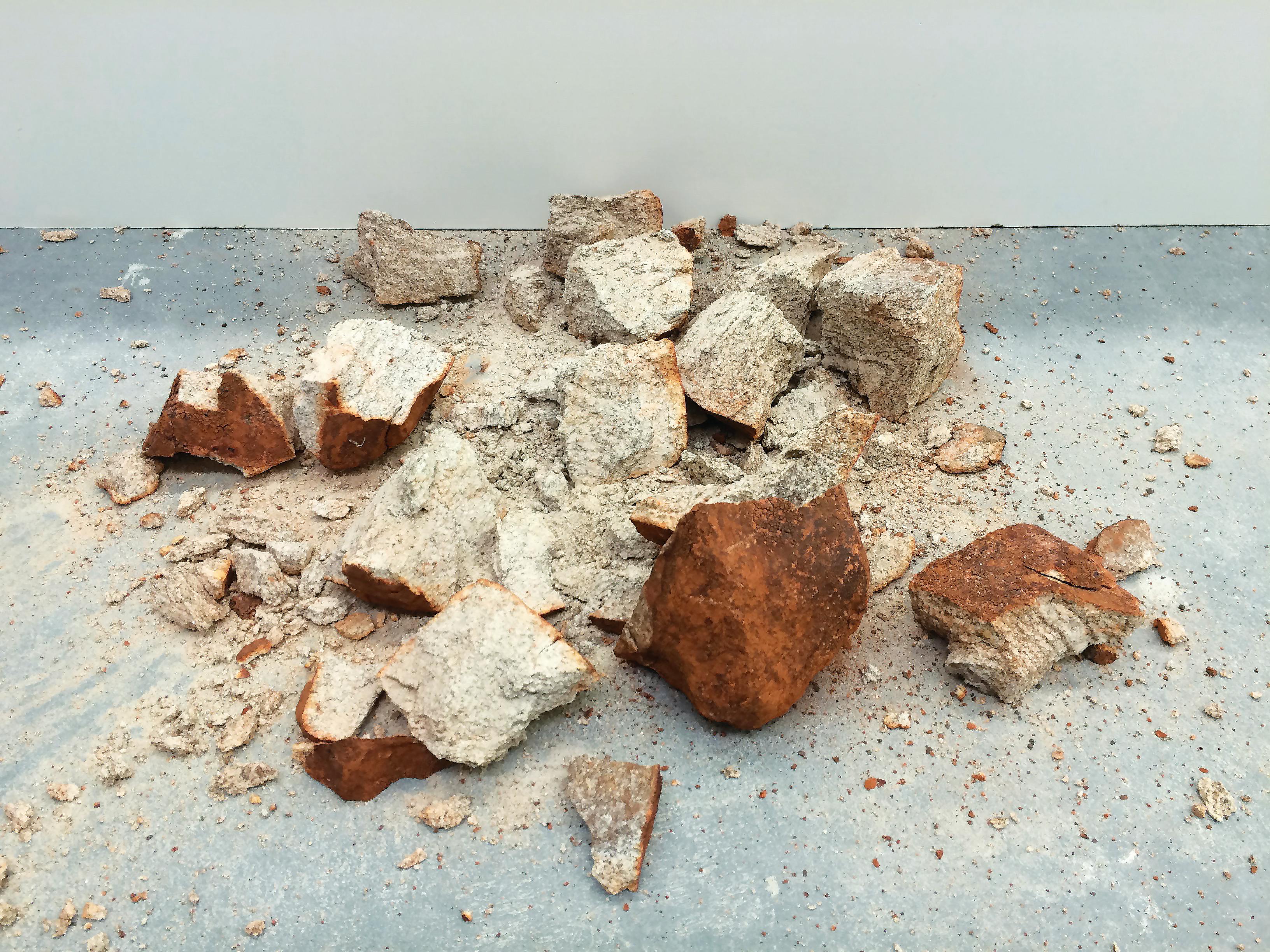 a large stone smashed into crumbly sandy pieces