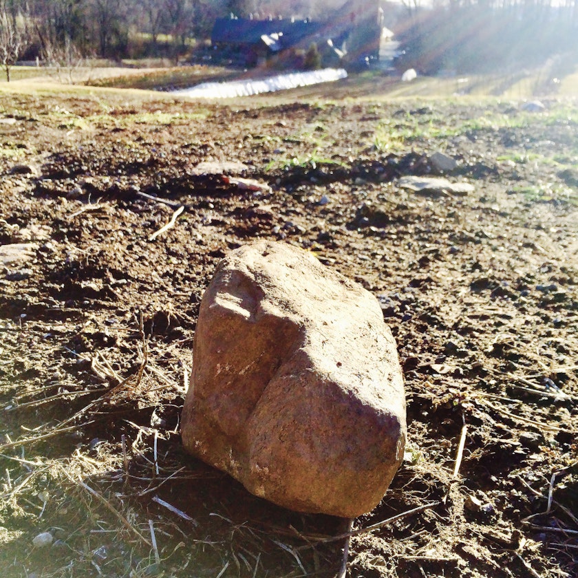large stone by itself in a field