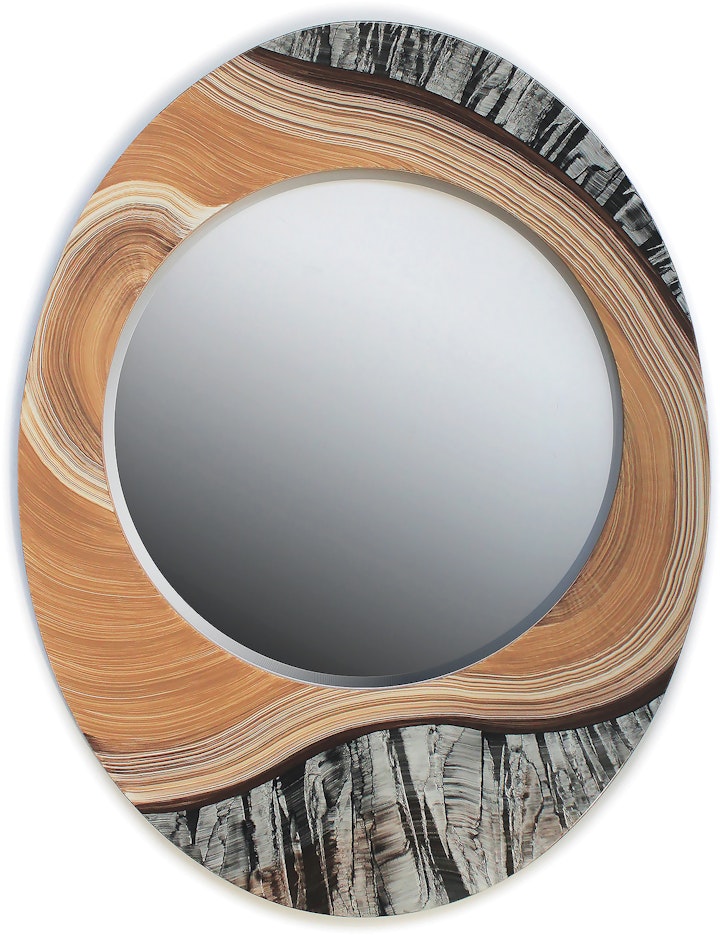 round mirror set in an ovular frame that looks like a cross-section of a tree with bark and rings