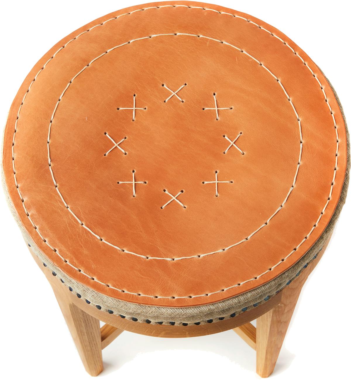 handmade stool with leather top featuring traditional upholstery techniques