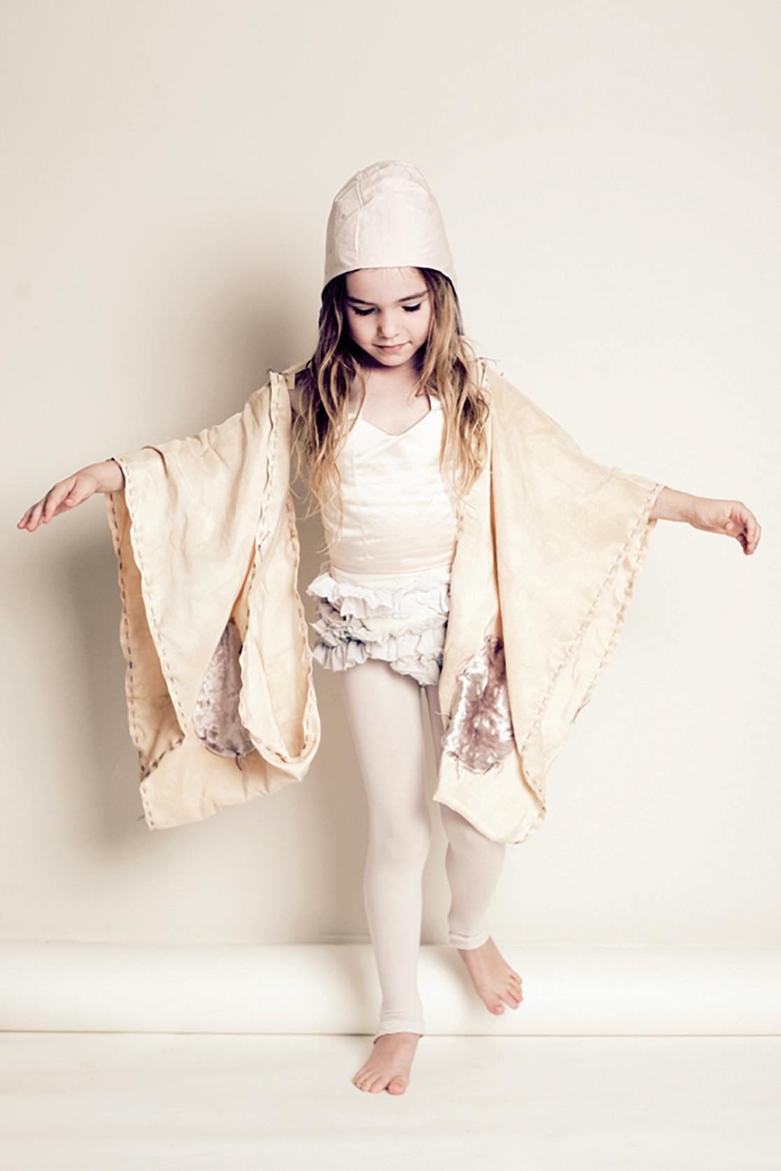 young model in dancing pose wearing tutu and hood