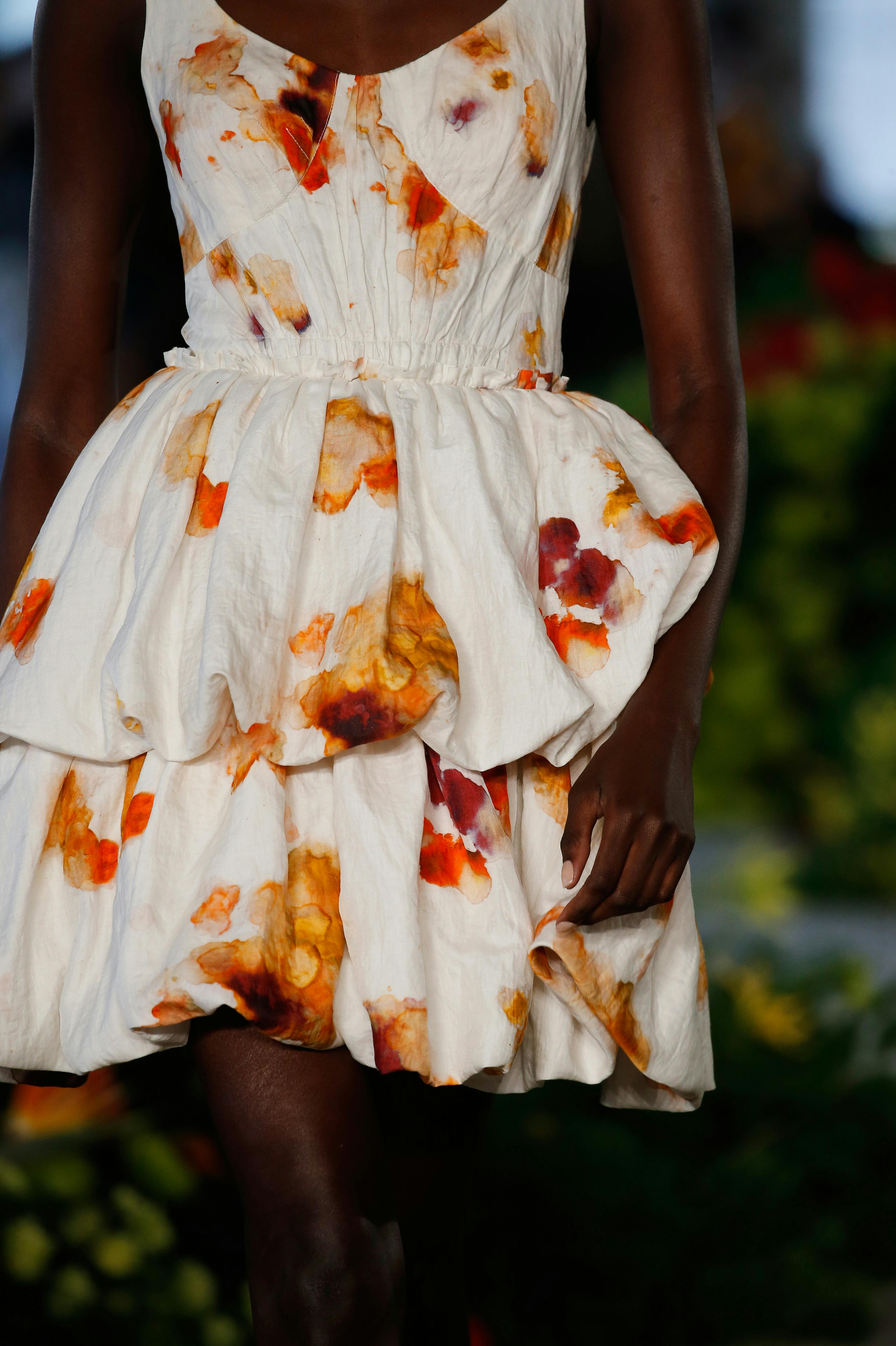 hand dyed dress that is white with orange blotches reminiscent of blossoms