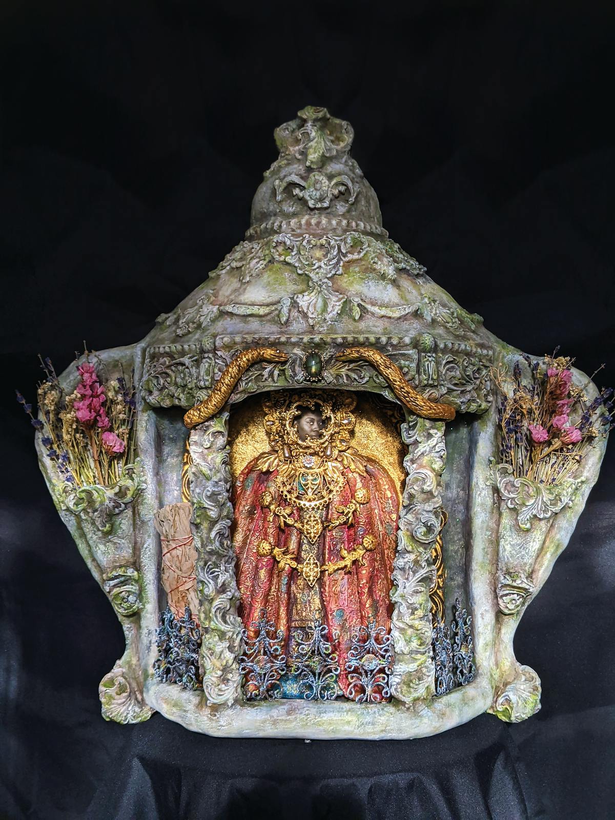 ornate clay alter shrine with flower motifs and gold coating