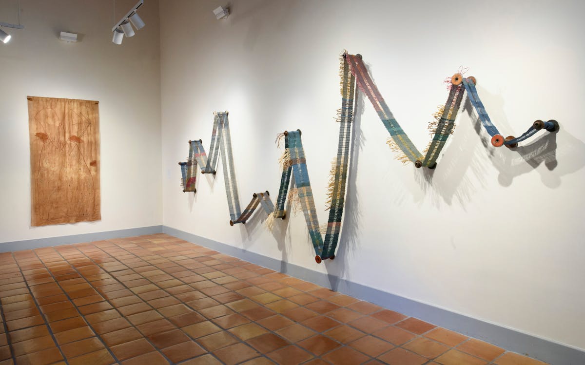 installation of a long thing weaving mounted in in a zig zag on the wall