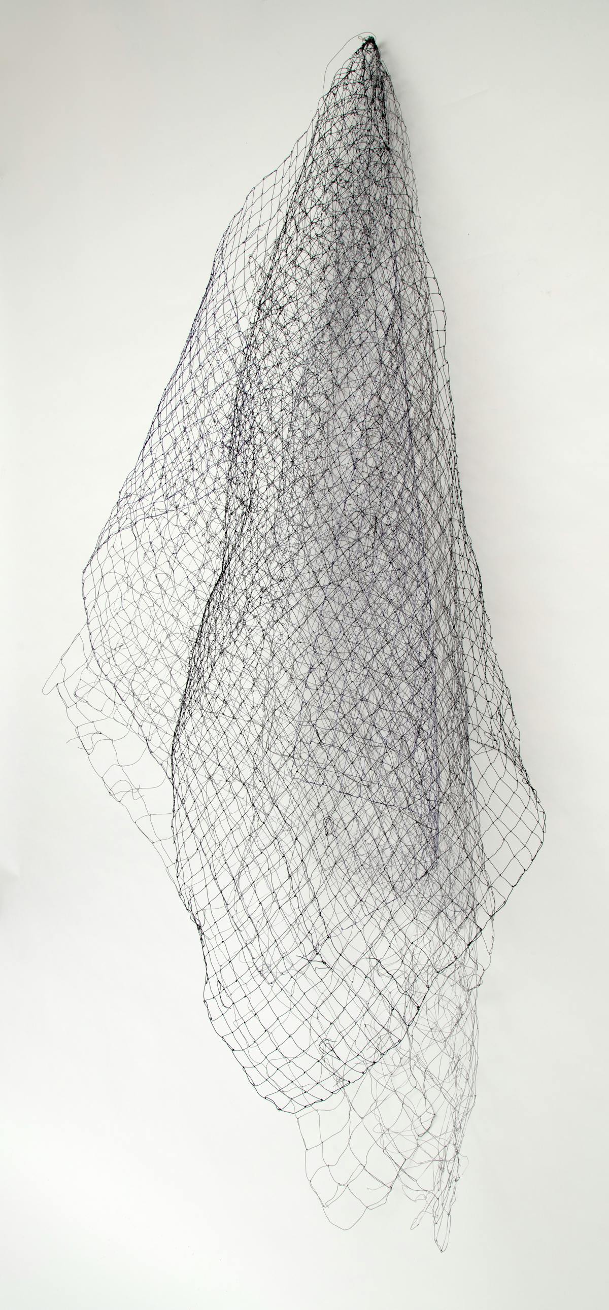 netlike textile artwork displayed as if draped on a hook