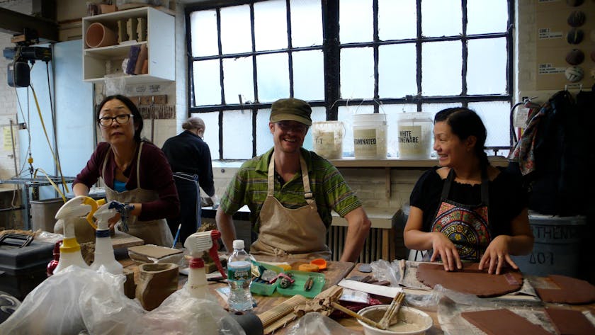 Three participants in a ceramics workshop