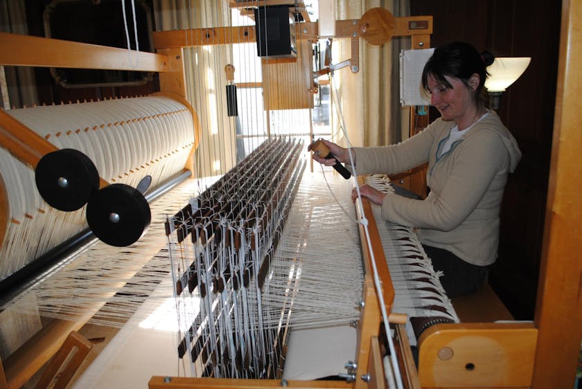 woman sitting at a traditional loom