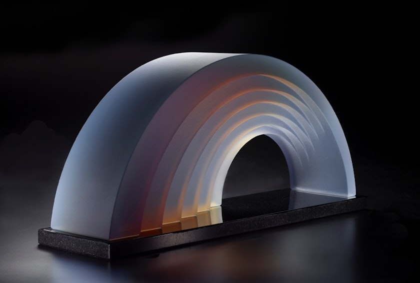 rainbow shaped glass object refracting subtle warm hues