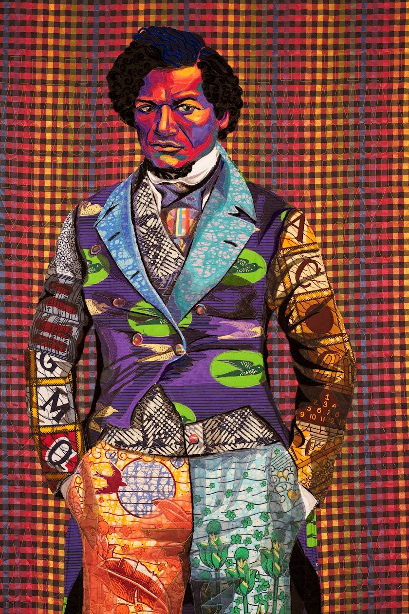 detail of a quilt depicting a young frederick douglas staring at the viewer wearing vibrant patterned clothing
