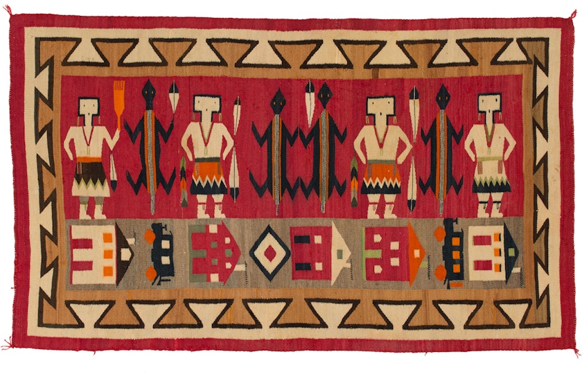 red orange tan and black navajo pictoral textile with people animals houses and train cars