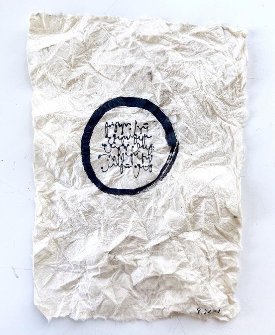 wrinkled fabric or craft paper with black osho and handwritten script