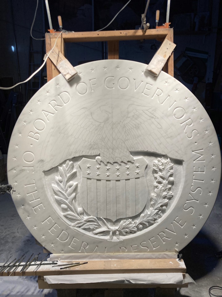 work in progress of a government crest and eagle carved in stone