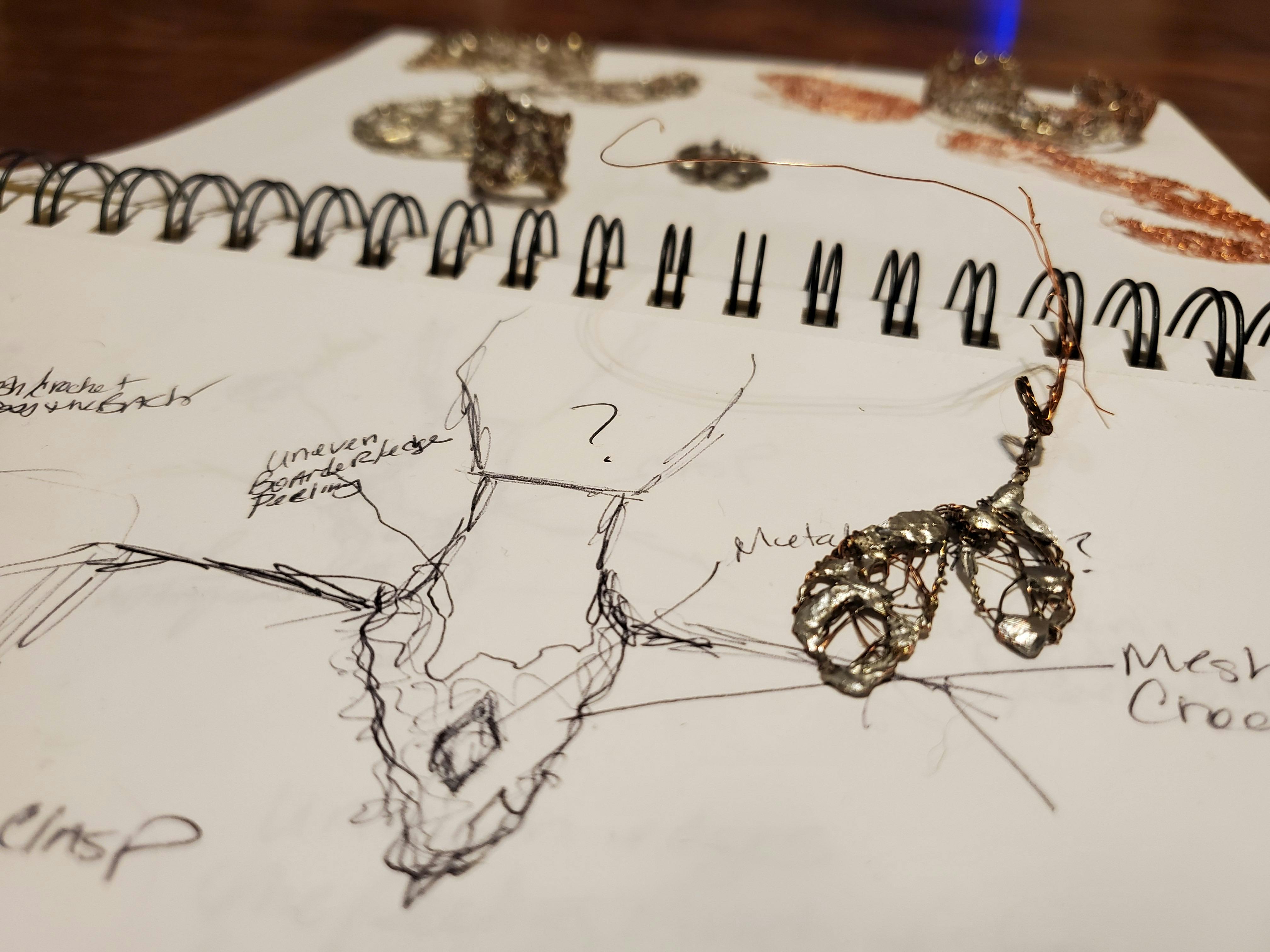notepad with sketch of jewelry art concept