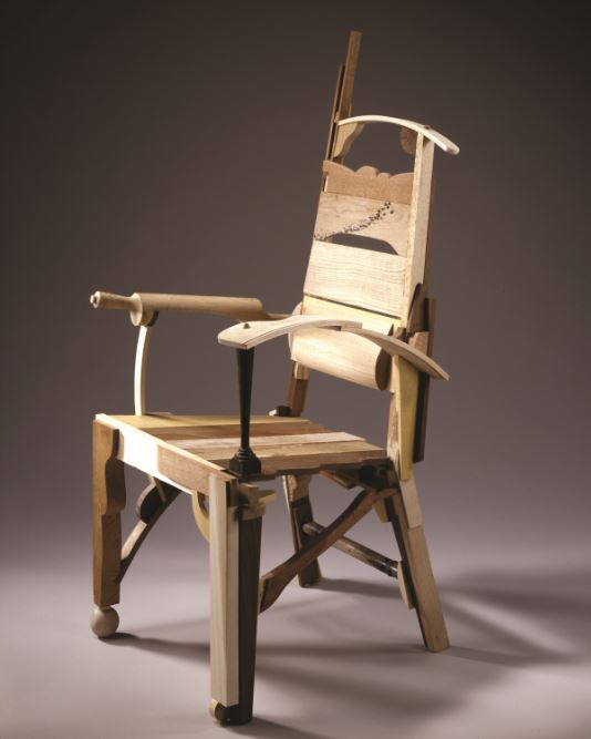 chair assembled from miscellaneous pieces of other wooden furniture and household objects