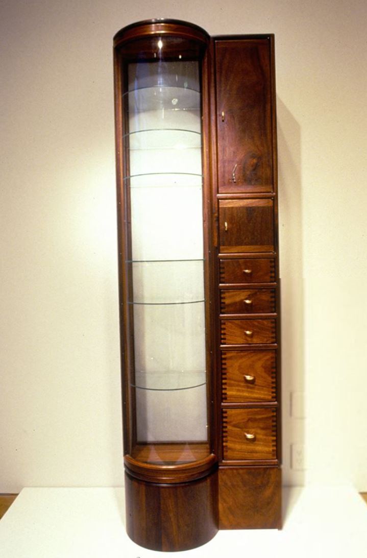 tall fine furniture cabinet with with curved glass shelving and various drawers
