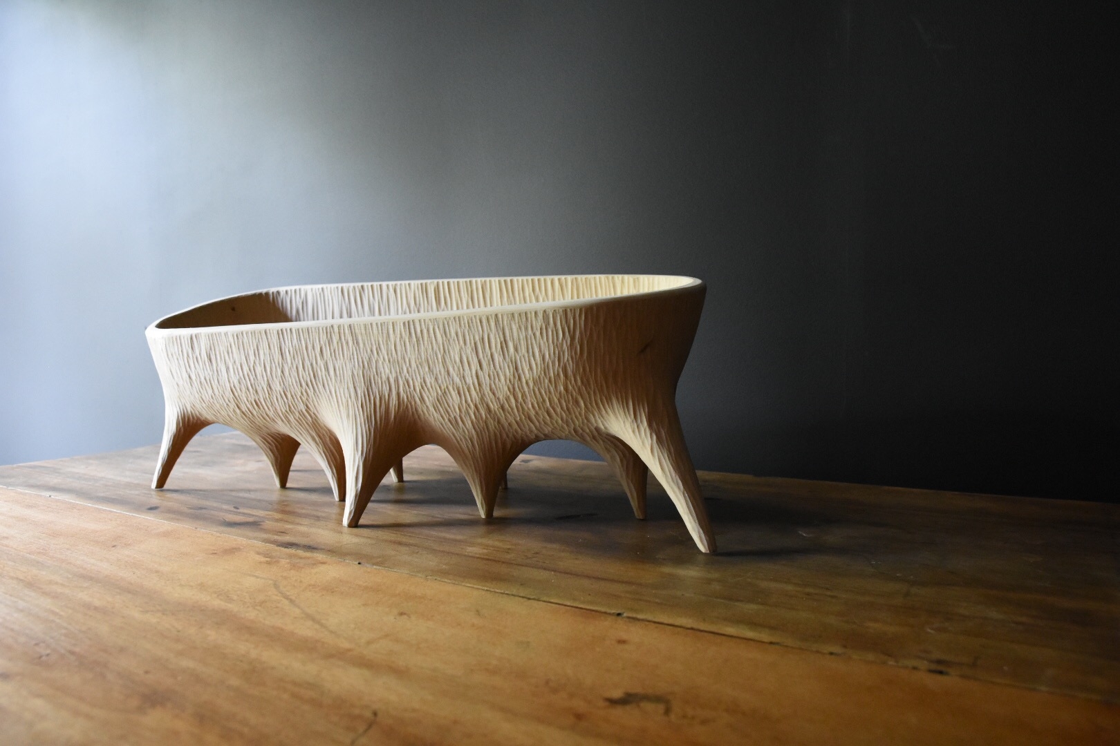 hand carved oblong wooden bowl displayed on a table