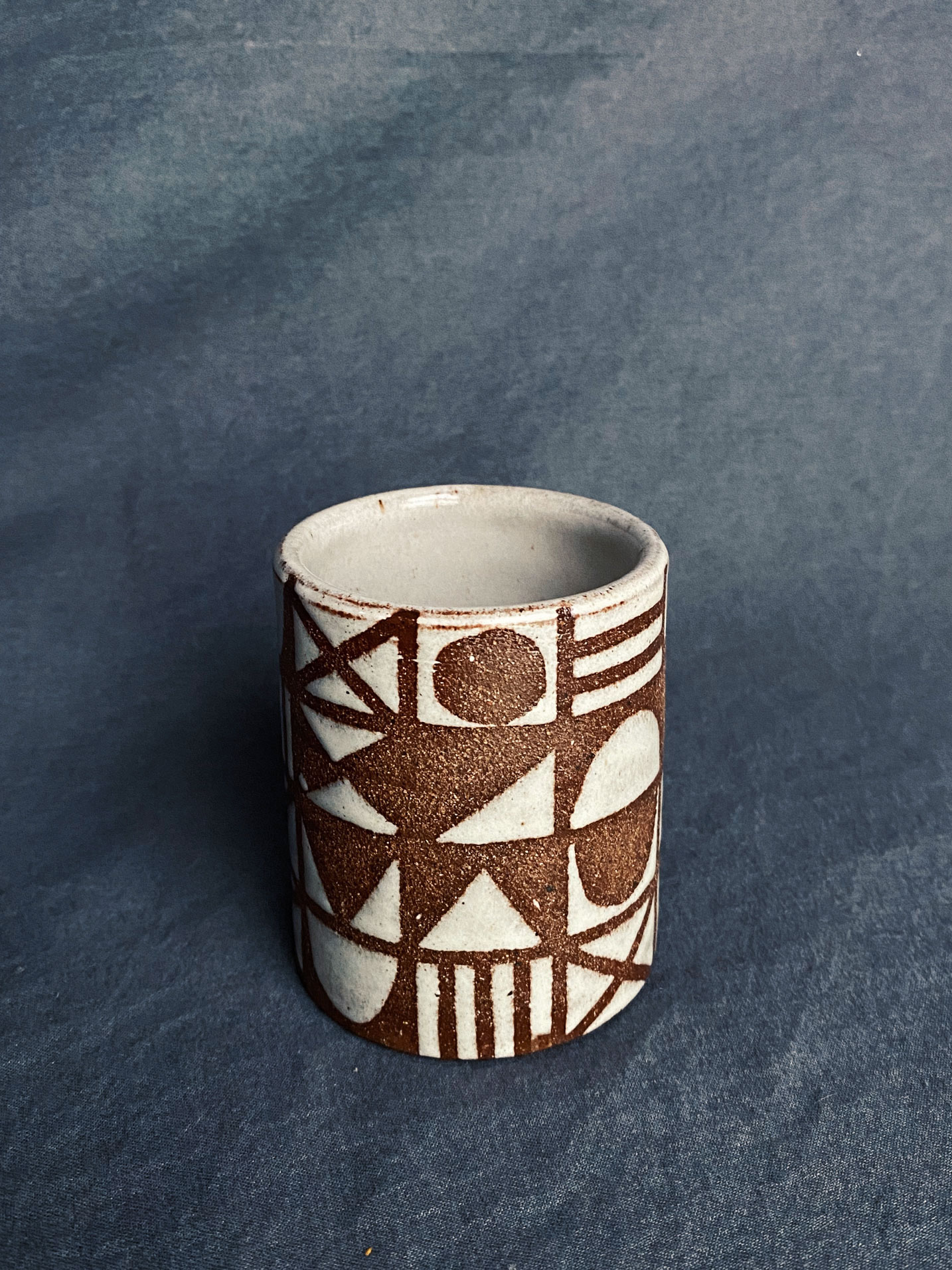 earthtone ceramic mug with pattern of geometric shapes