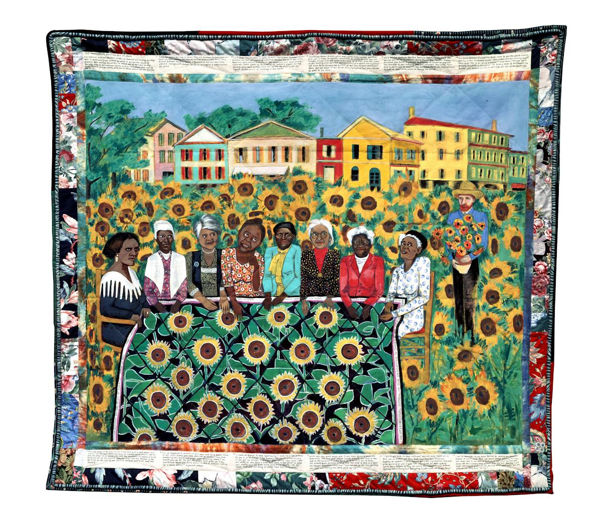 quilt showing group of women seated around a quilt with sunflower pattern in the midst of a sunflower field with the painter van gogh standing nearby and a grouping of buildings in the backdrop