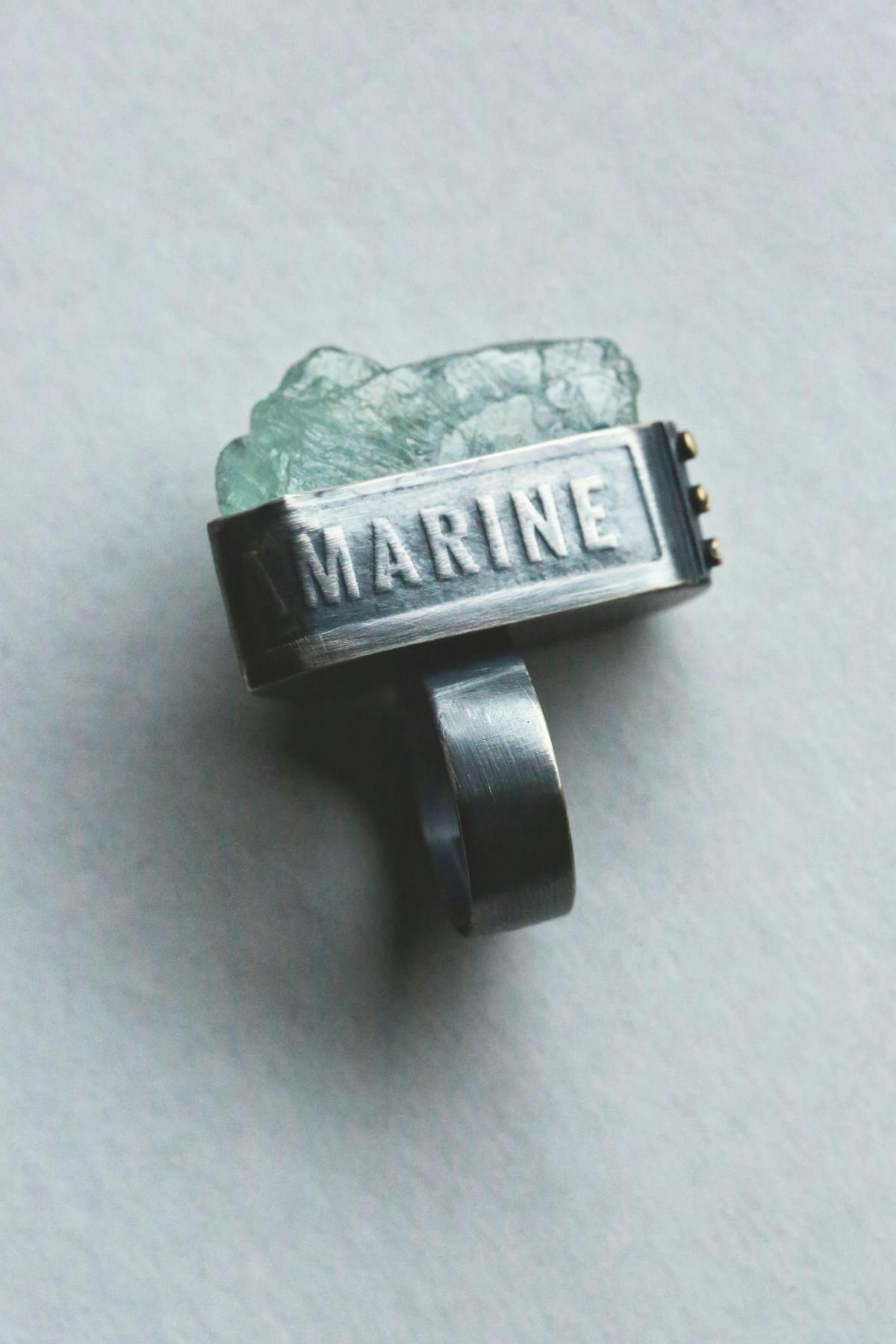 ring with raw gemstone and the word marine