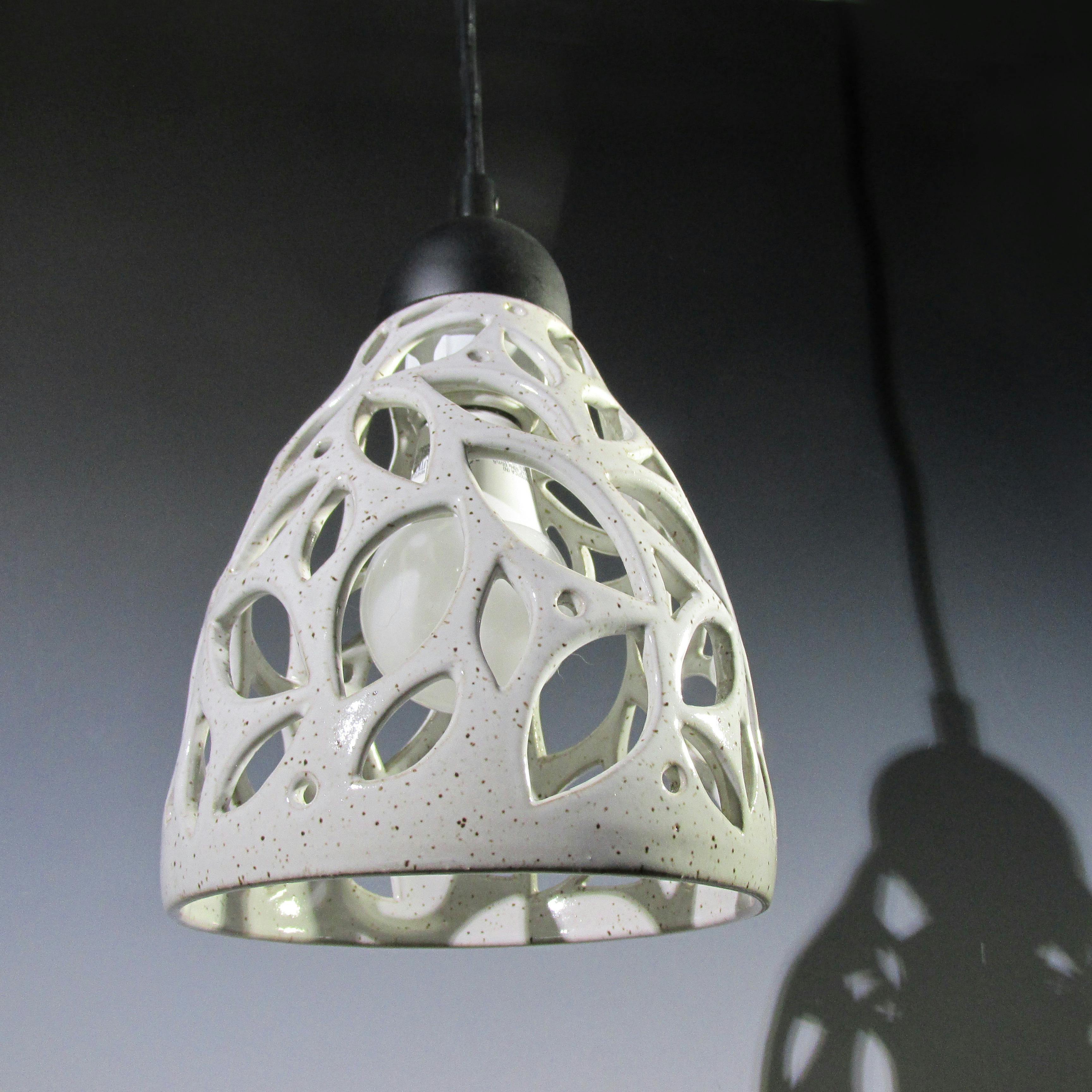 ceramic light ficture with leaf like openings for light to shine through