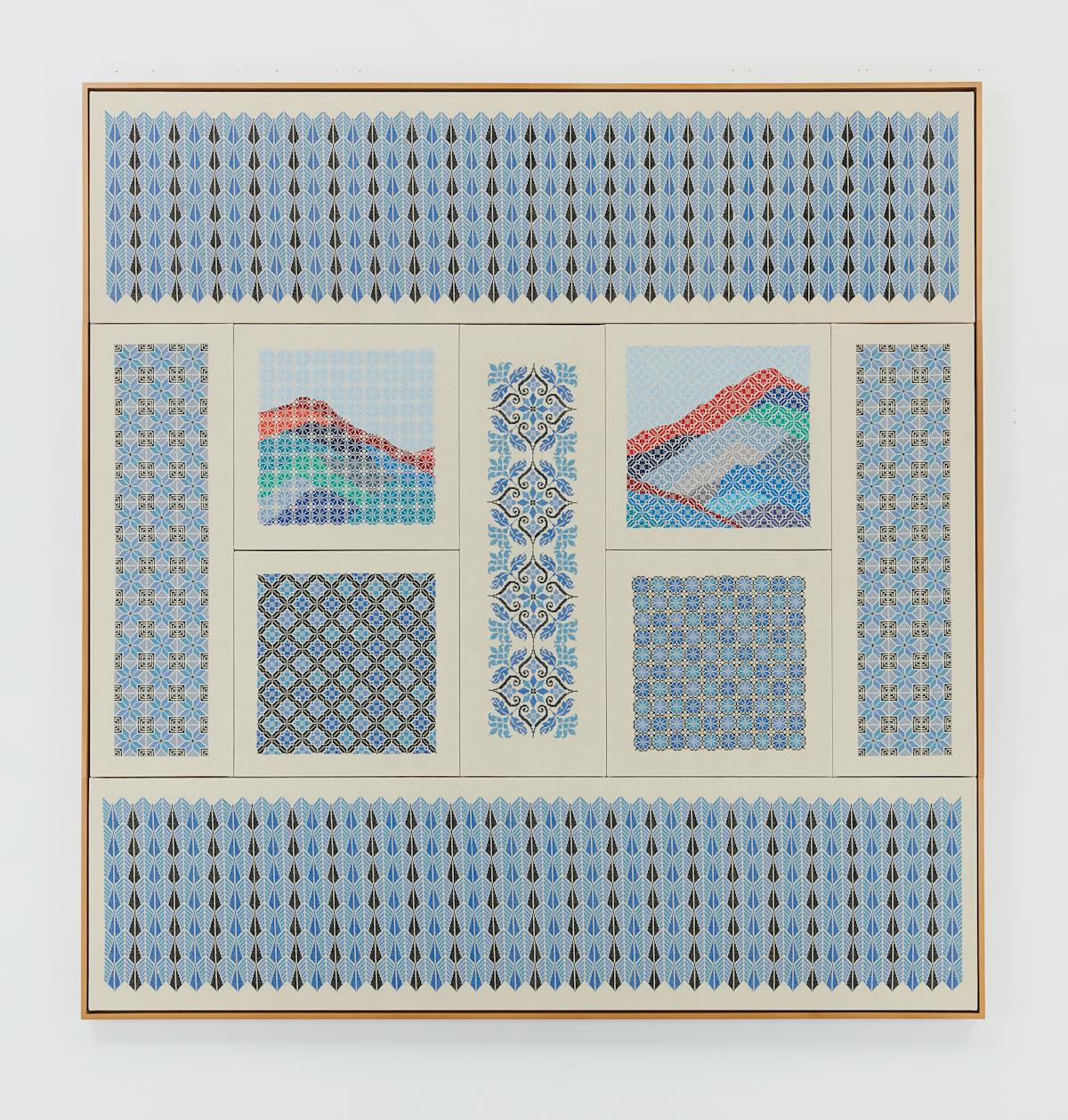 framed embroidered wall art with various pannels of blue patterns