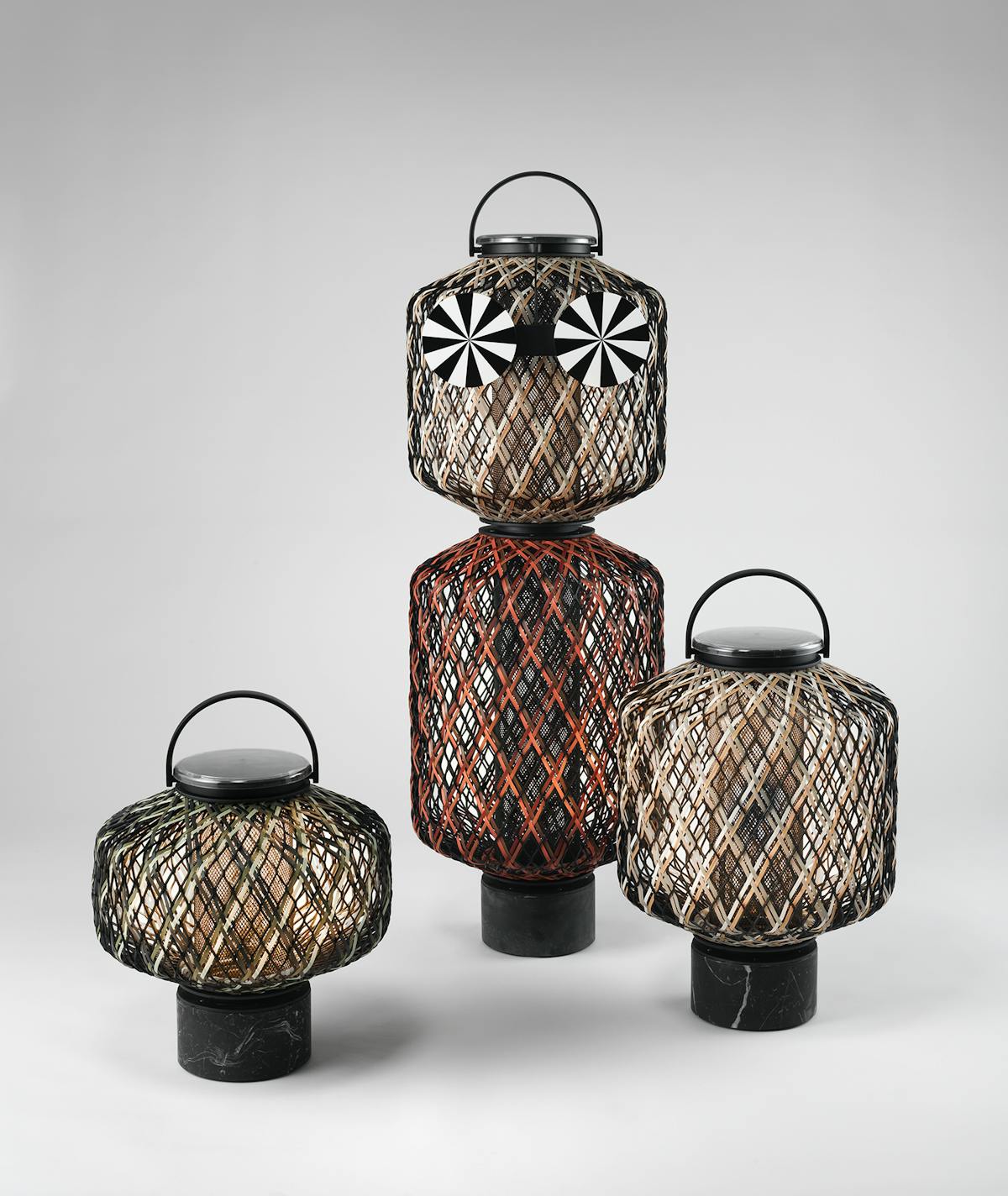 three woven lanterns of various sizes with red and black detailing
