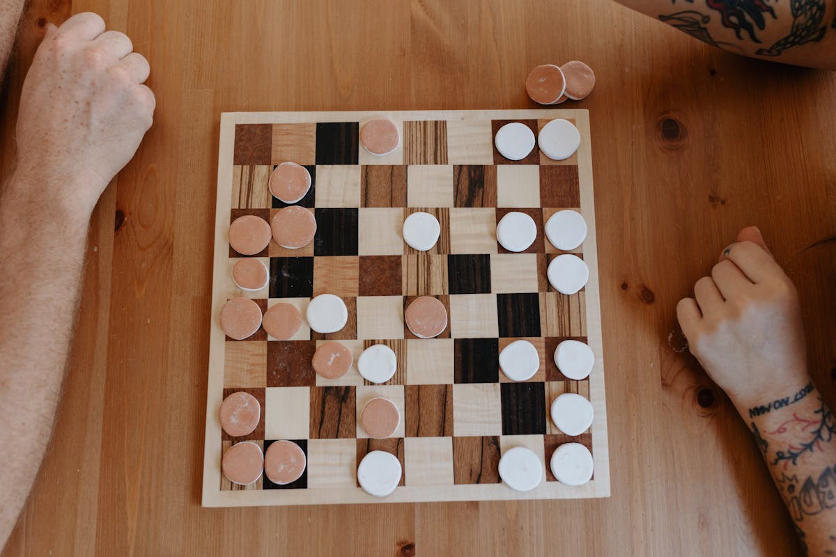 Wood checkers board with ceramic pieces