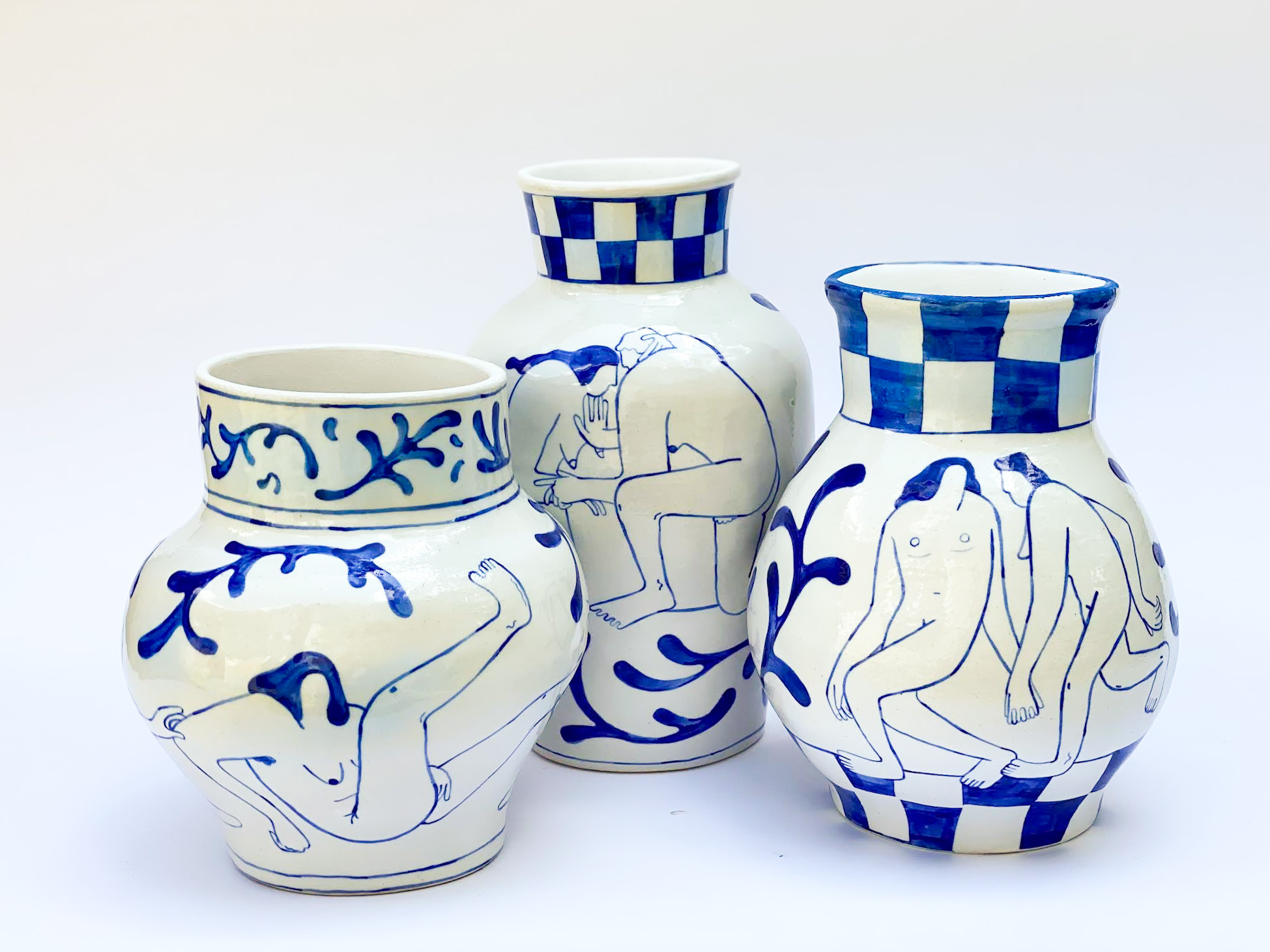 Blue and white ceramic jars with line drawings of people