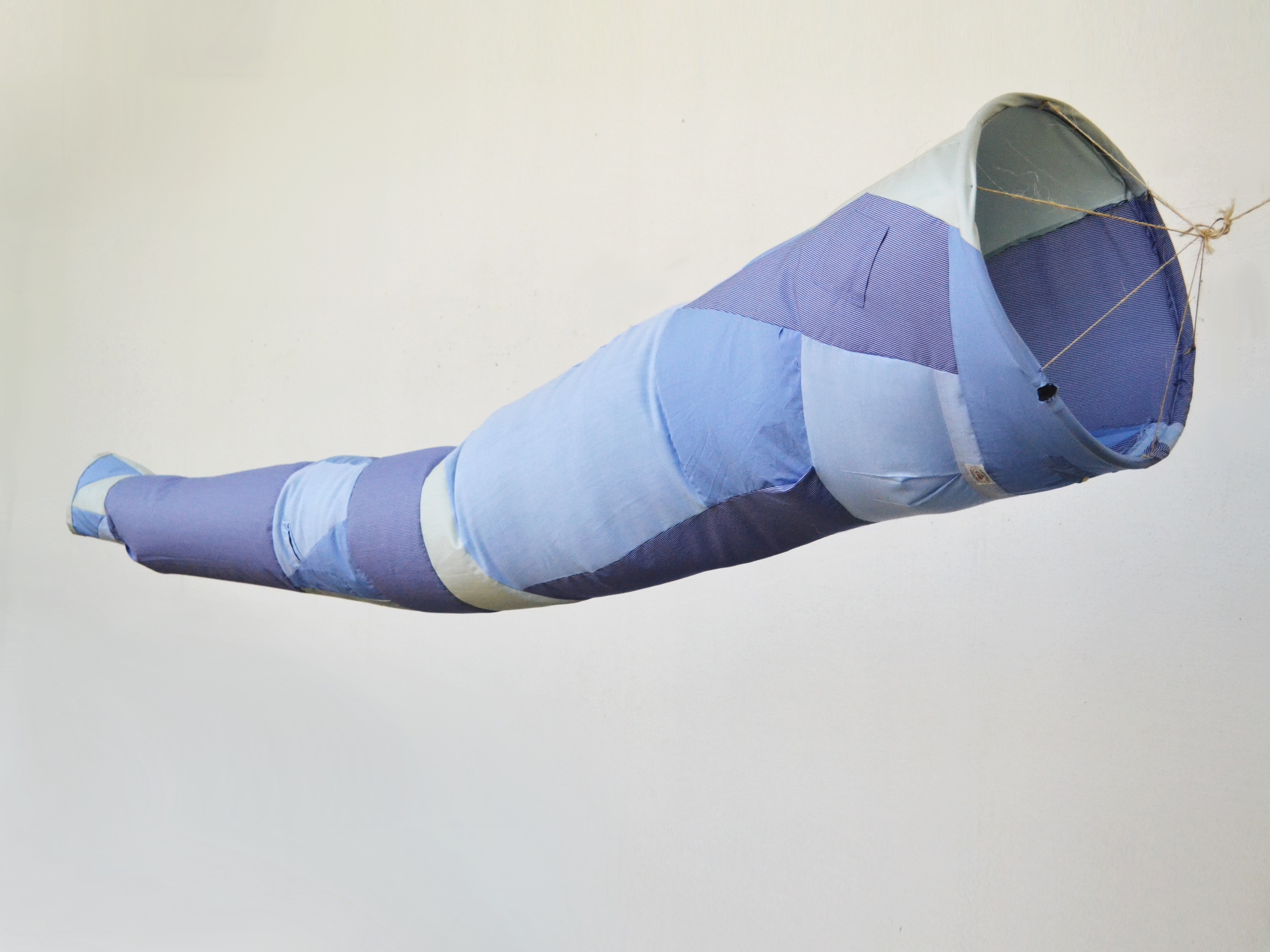 Wind sock made from various blue fabrics to look like a sleeve