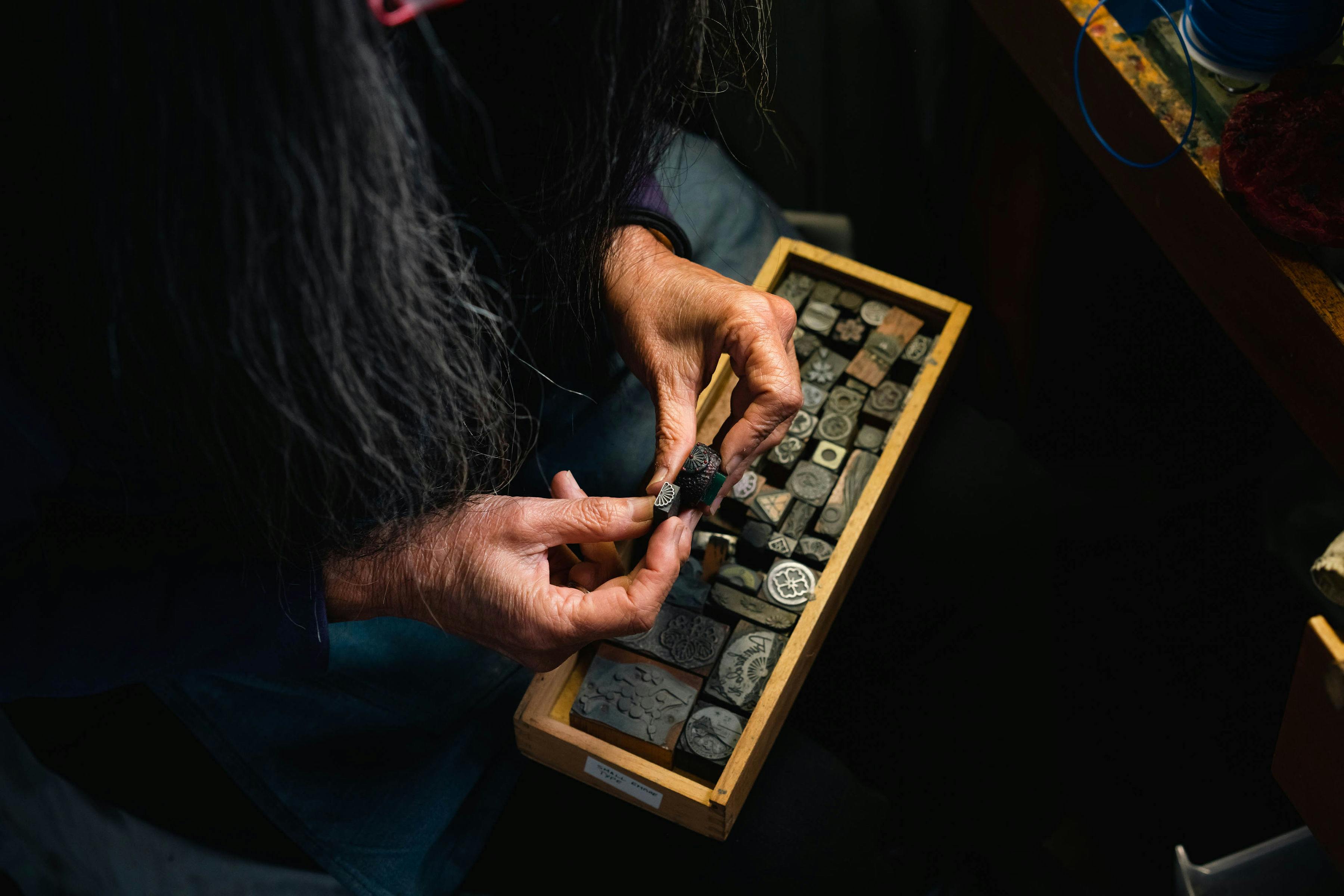 Suzye Ogawa holds ornate letterpress type