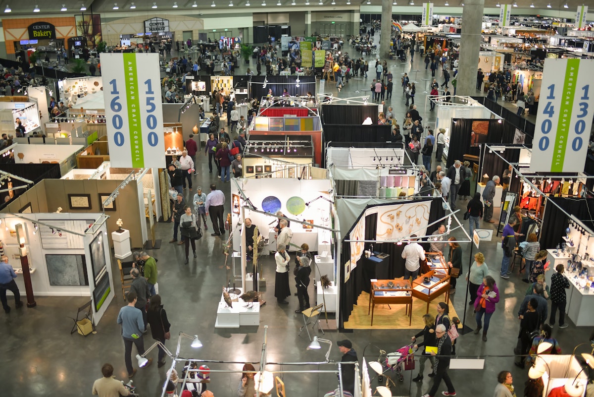 Overhead shot of busy craft show floor with rows of artist booths